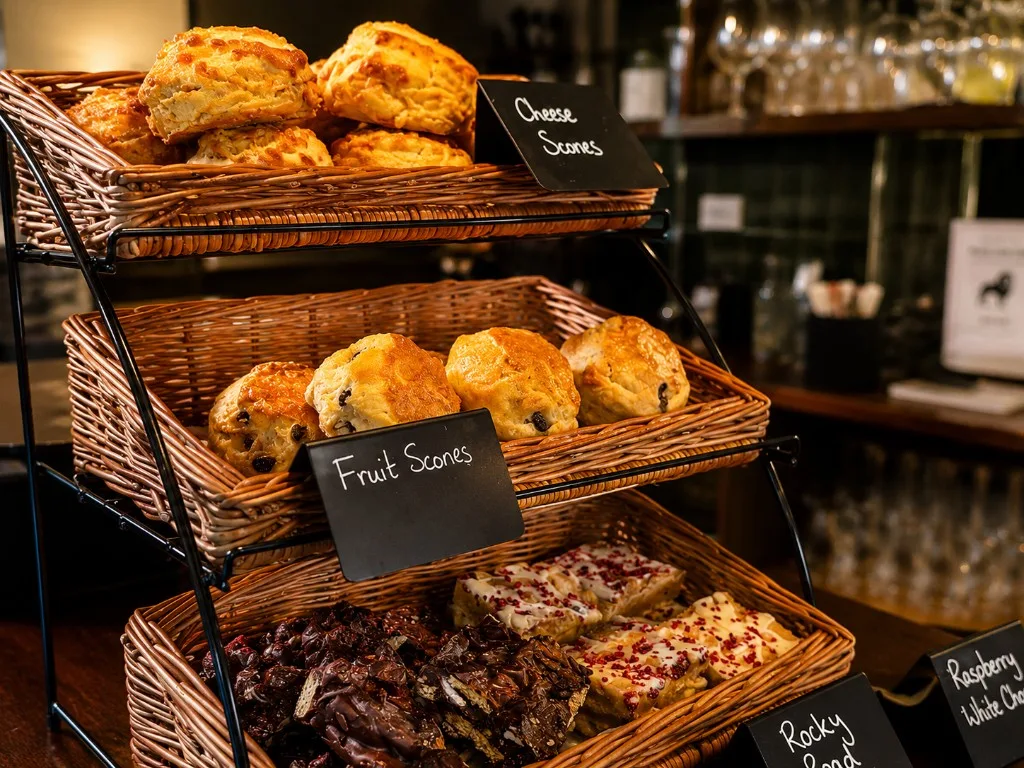 Cheese scones, fruit scones and homemade slices on the café stand