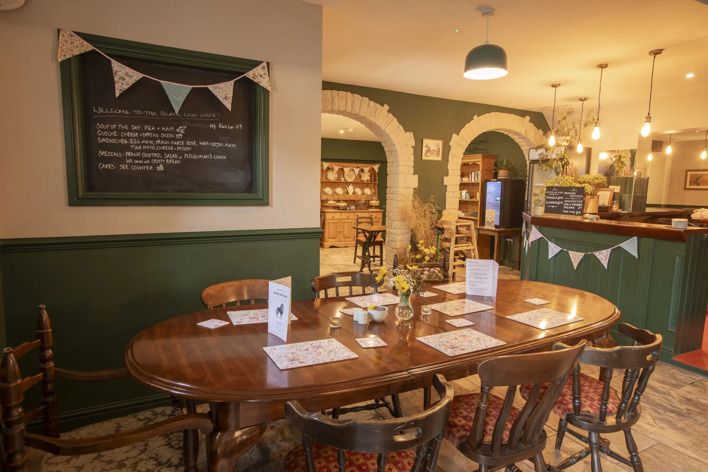 A long table set for a gathering in the café rooms at The Black Lion