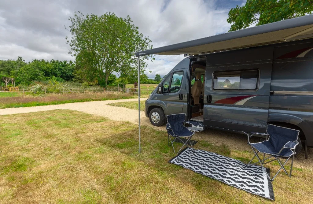 Campervan on a hardstanding pitch with awning