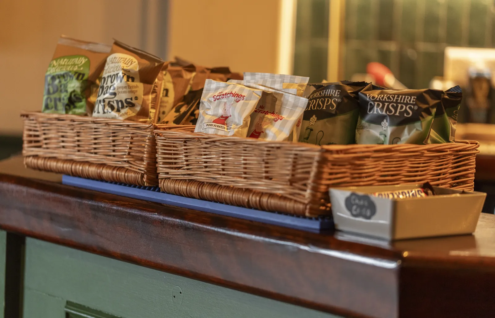 Baskets of crisps and pork scratchings on the bar