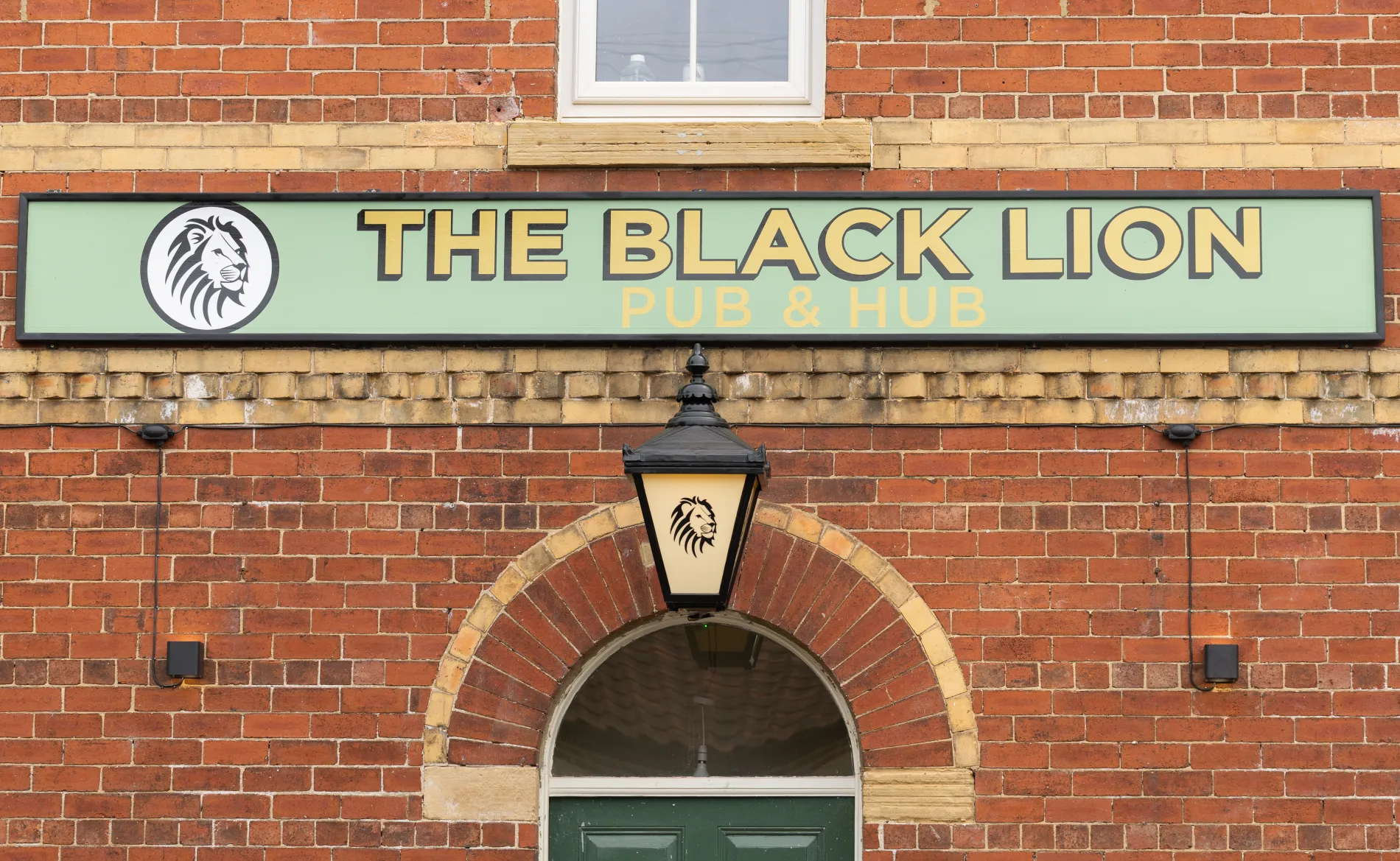 The Black Lion Pub and Hub sign over the entrance