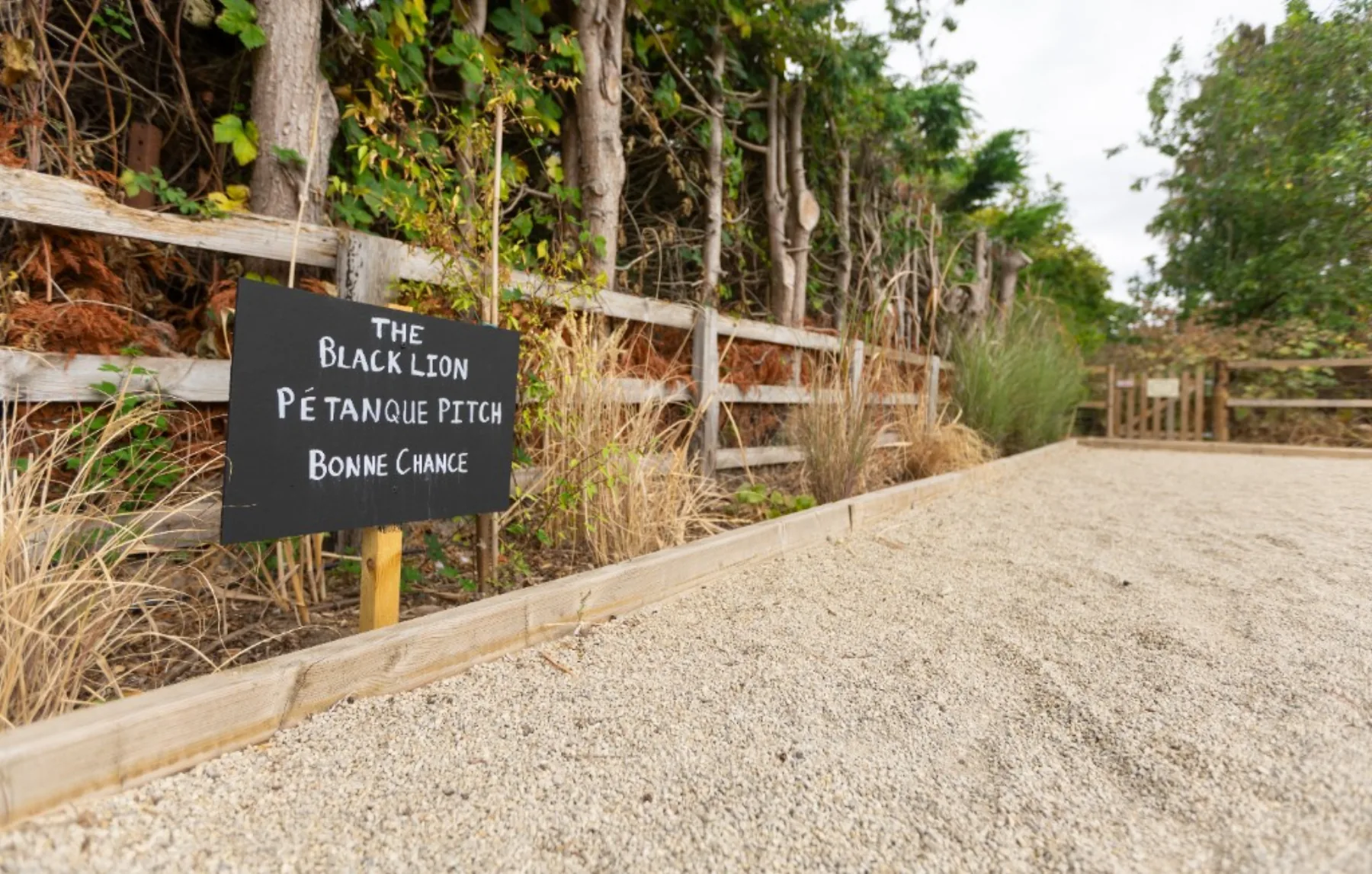 The Black Lion pétanque pitch sign reading Bonne Chance