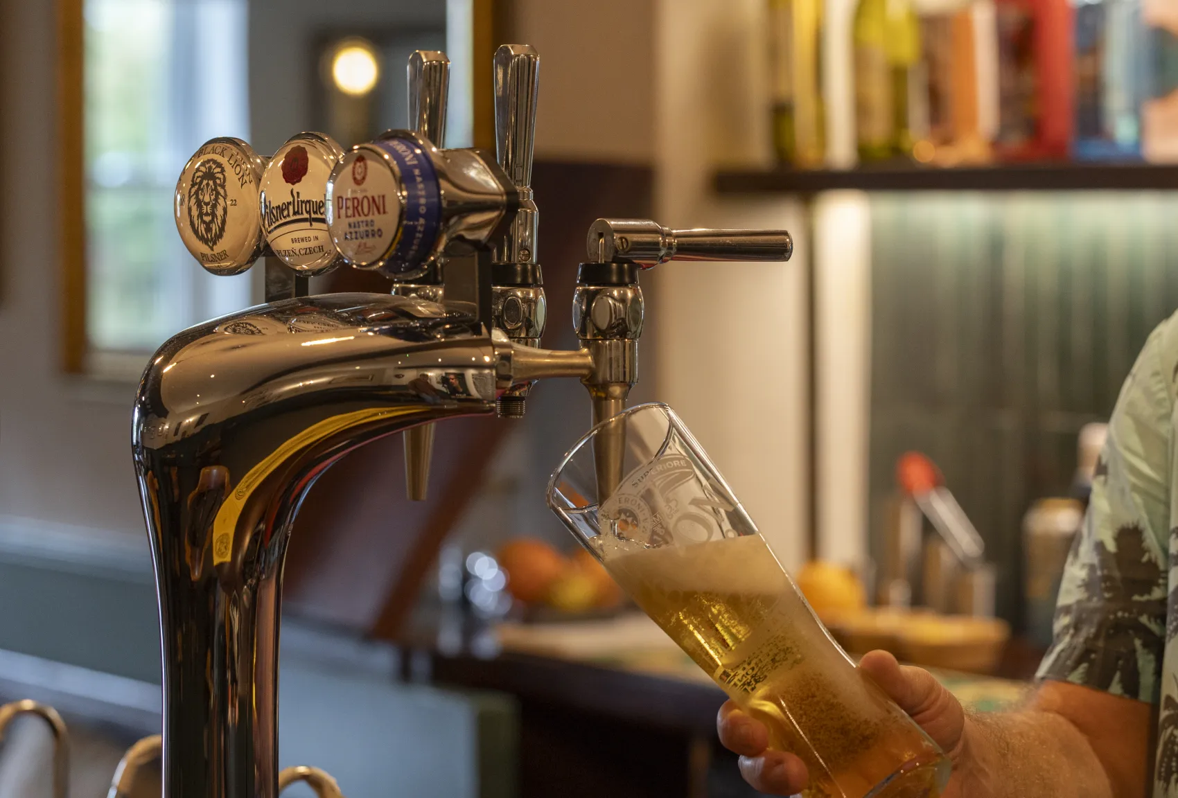 A pint of lager being poured from the bar taps